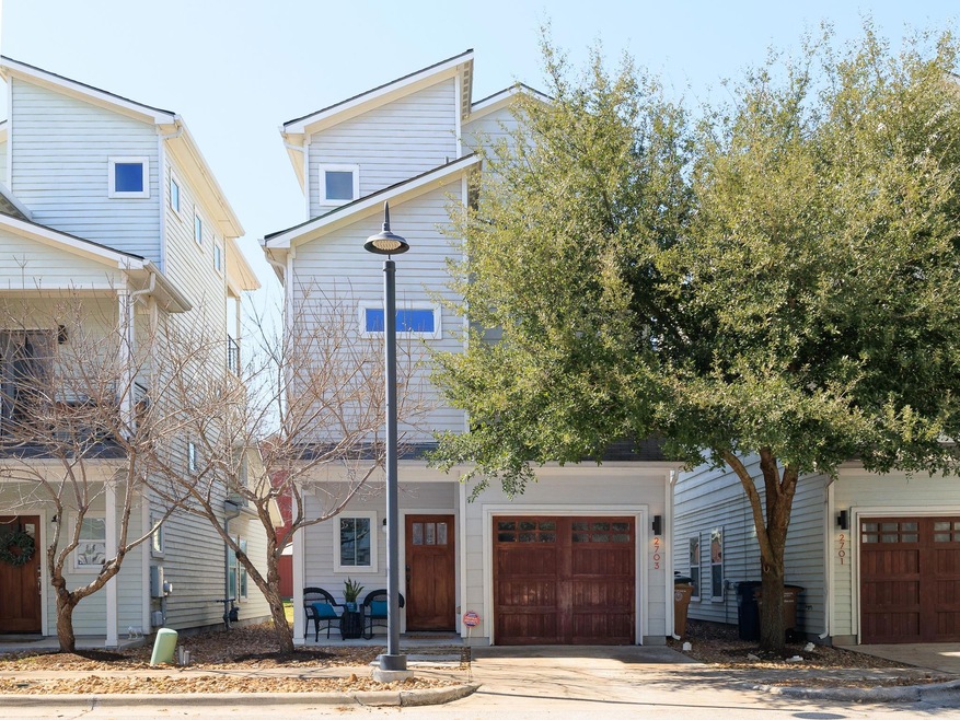 View of front of property with a garage and drive
