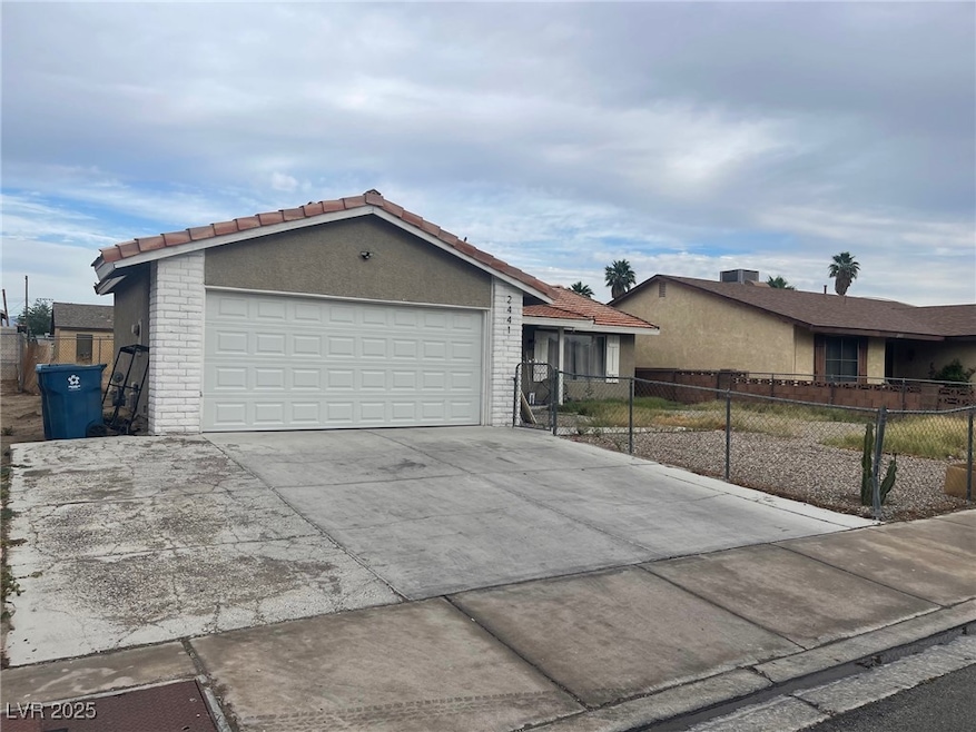 Ranch-style home with concrete driveway, brick sid
