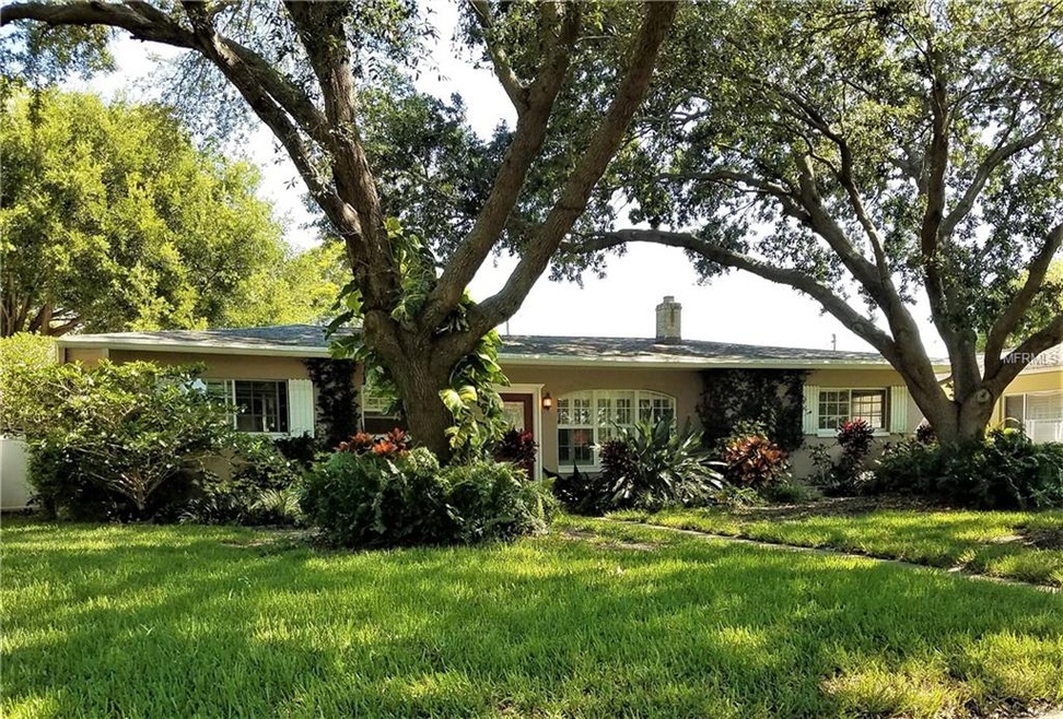 A shady, lush green landscaping greets you upon ar