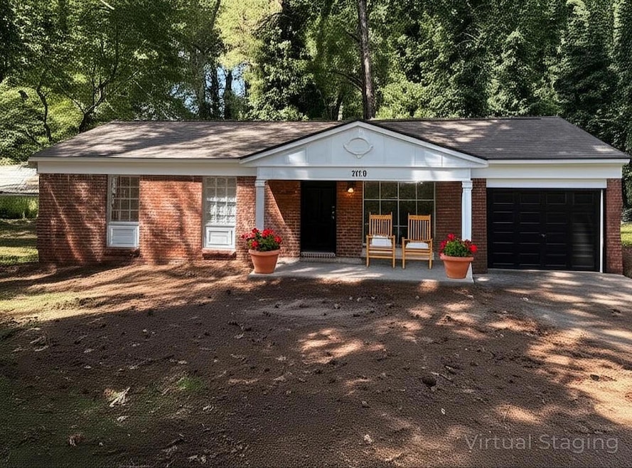 Ranch-style home featuring brick siding, a garage, a porch, and driveway