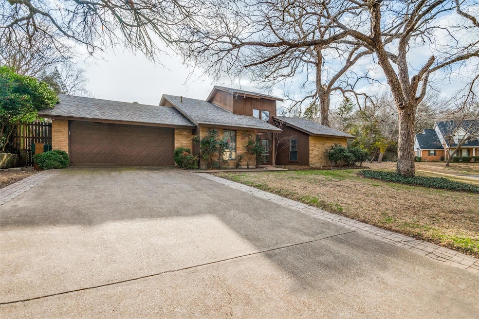 Mid-century inspired home featuring a garage, bric