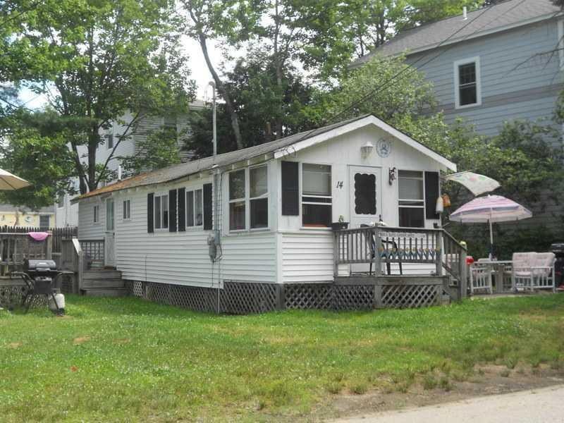 Exterior Front. White cottage condo...