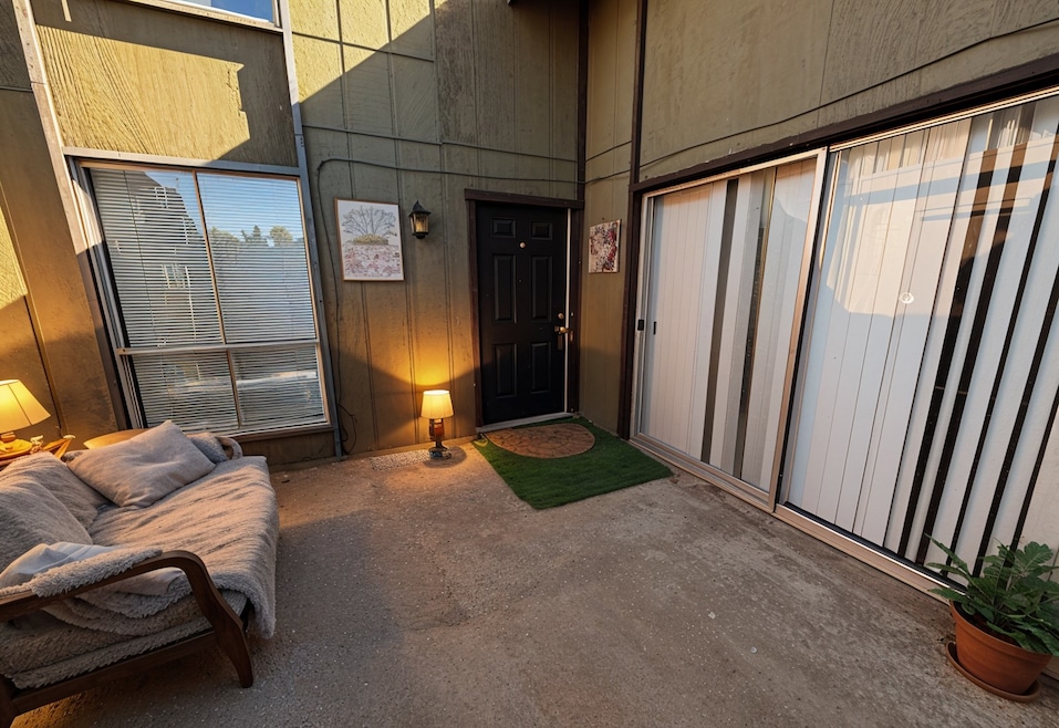 Doorway to property featuring a patio