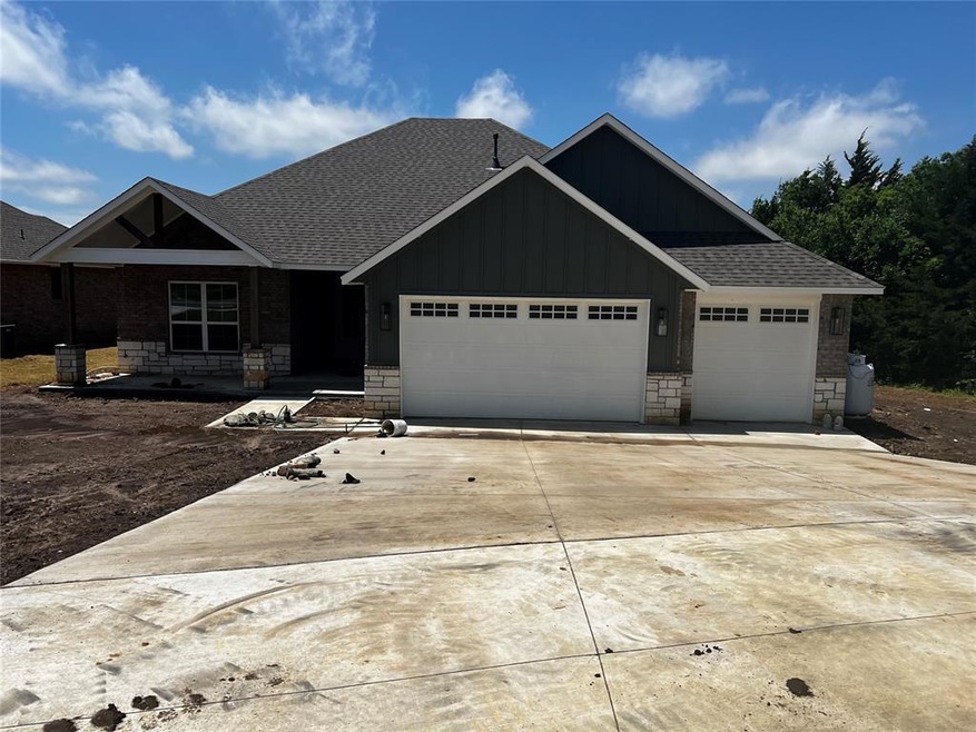 Craftsman inspired home with a shingled roof, board and batten siding, a garage, and stone siding