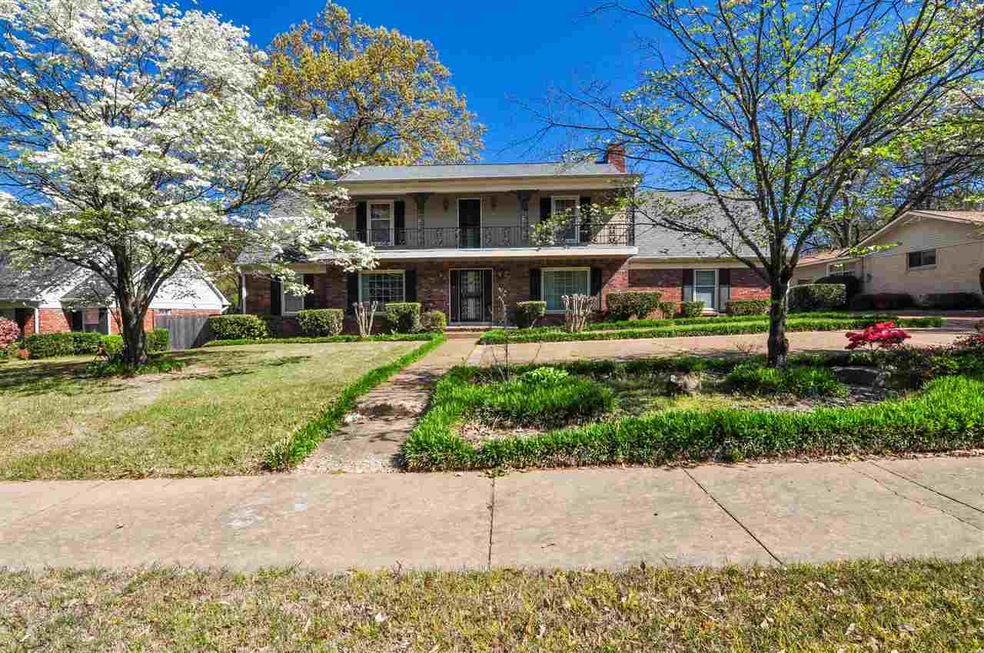 This home features a covered porch and upper balco