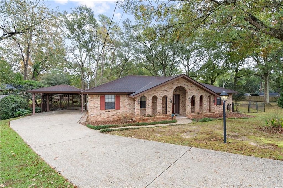Ranch-style house with a front lawn and a carport