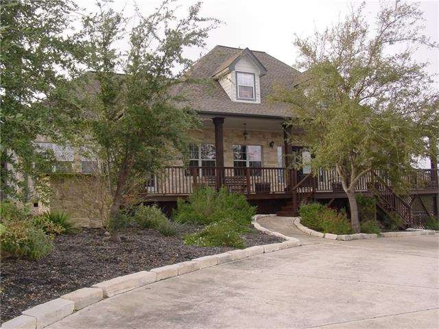 Front with huge covered deck patio with circular d