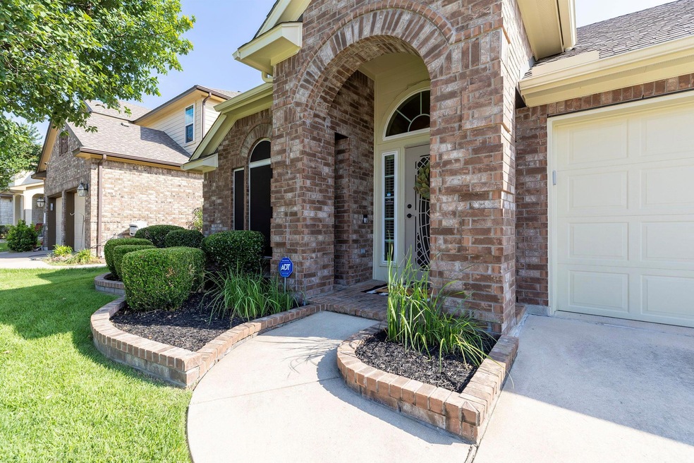 Doorway to property with brick siding, roof with 
