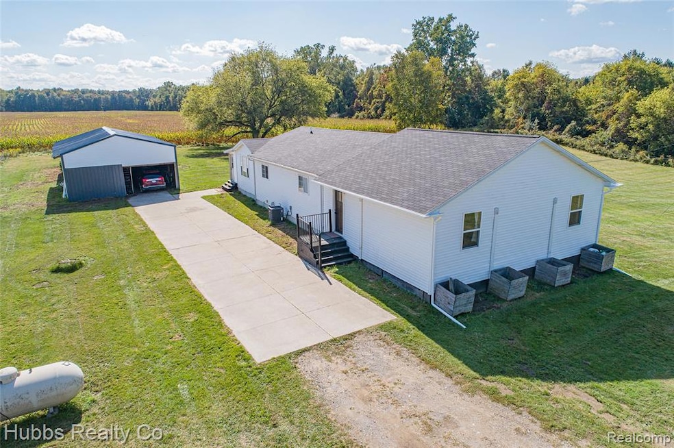 Front of home, driveway and pole barn