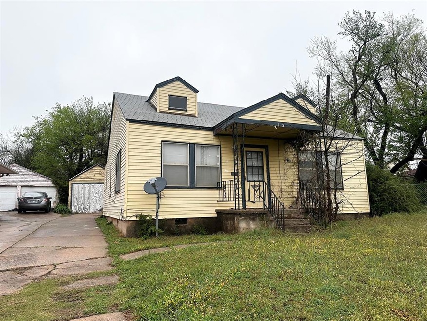 View of front of home with a garage and a front la