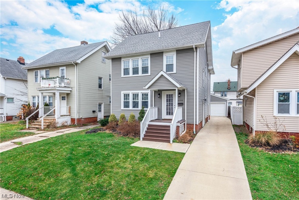 View of front of property with a garage, and a front yard.