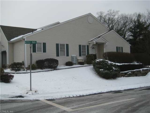 Exterior Front. End unit perched on hill.