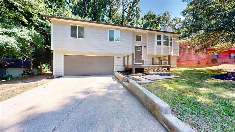 Split foyer home with a garage and a front lawn