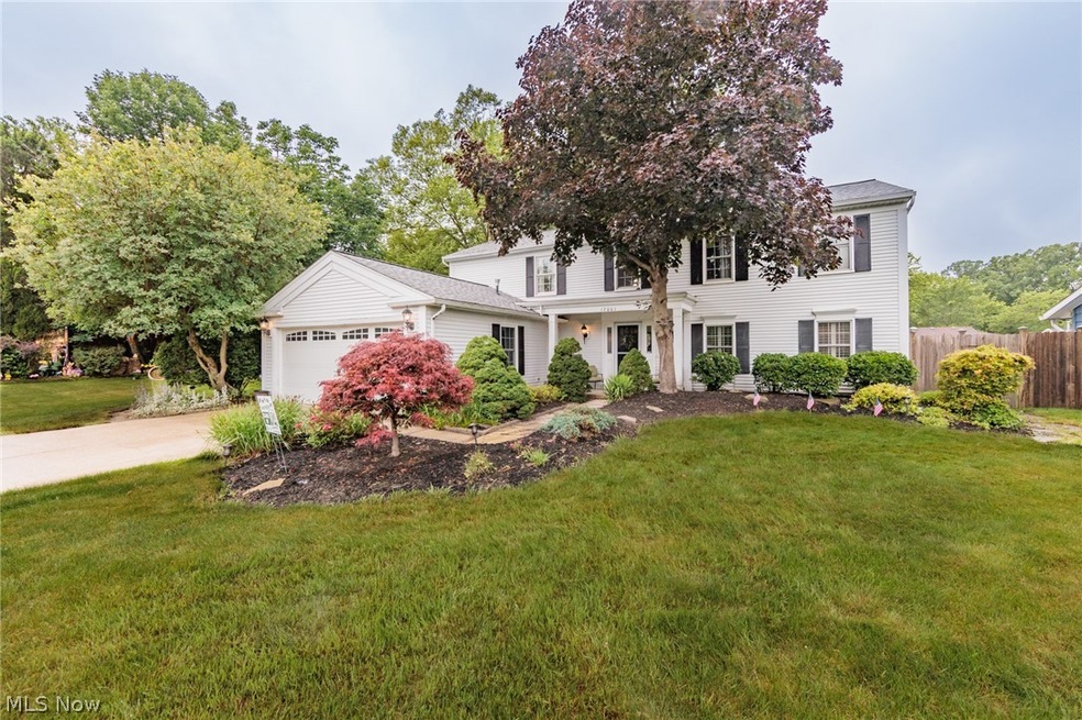 View of front of house featuring a garage and a front yard