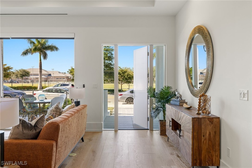 Doorway featuring baseboards and light wood-type f