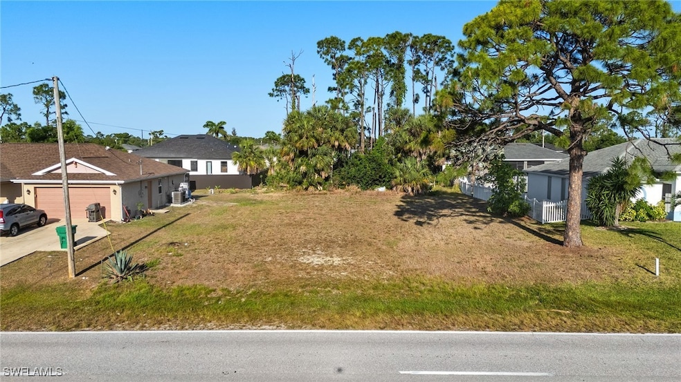 View of yard featuring a garage and driveway