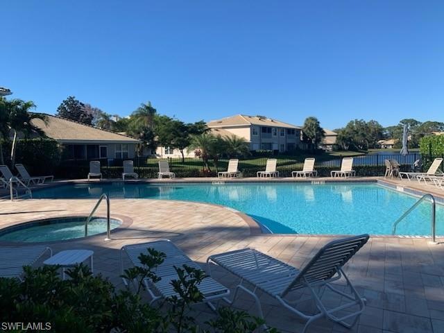 View of pool featuring a community hot tub and a p
