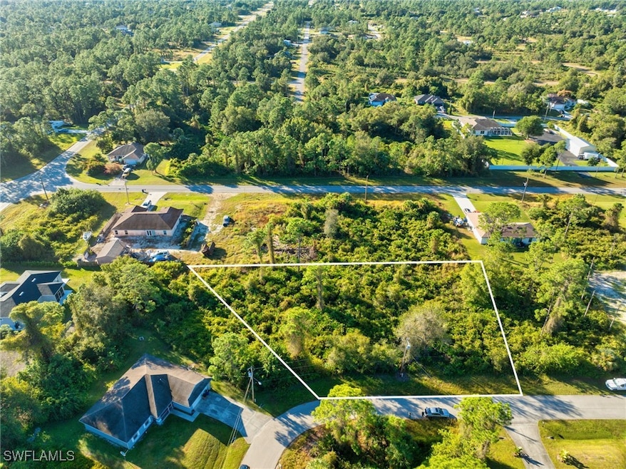 View of property location with a heavily wooded area and property boundaries highlighted