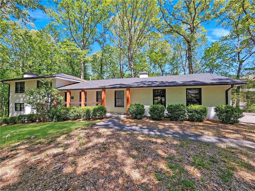 View of front of property featuring a chimney and a porch