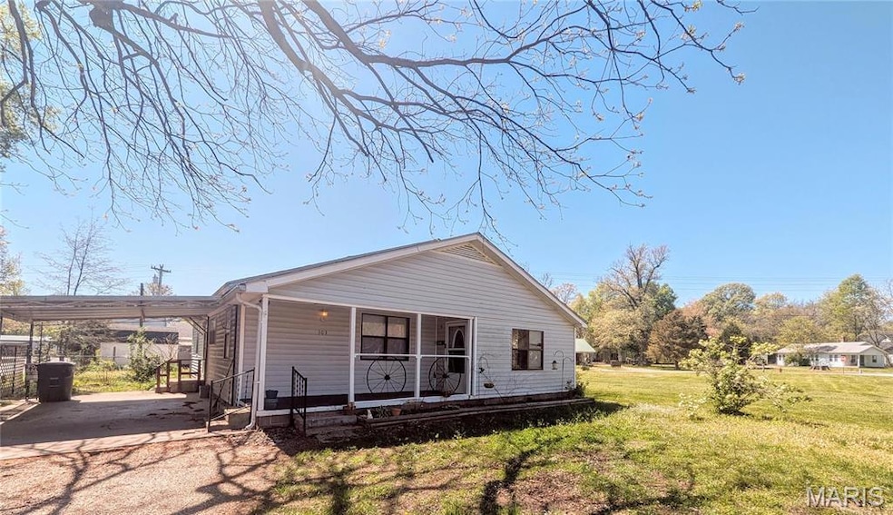 Bungalow-style home with a front yard, covered porch, and an attached carport