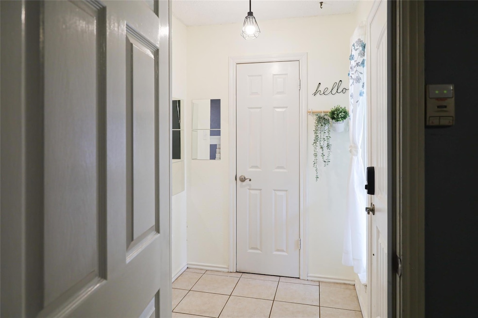 Entryway with light tile patterned flooring