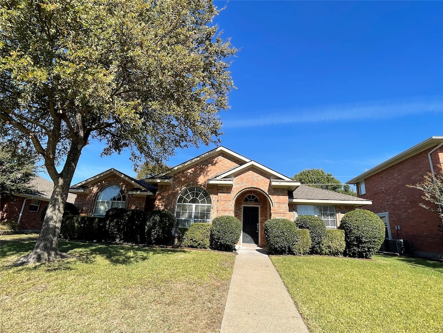 Single story home featuring a front yard and brick siding