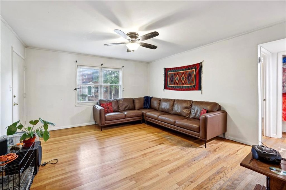 Living room with ceiling fan, ornamental molding, 