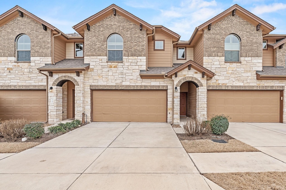 View of front of house with a garage, driveway, a