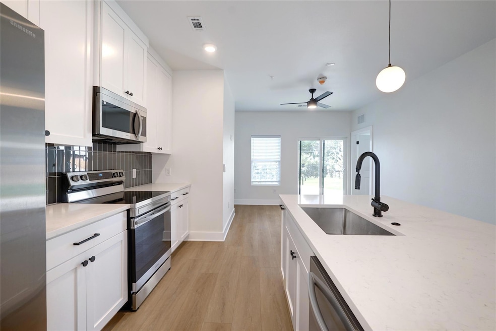 Kitchen with stainless steel appliances, a sink, 