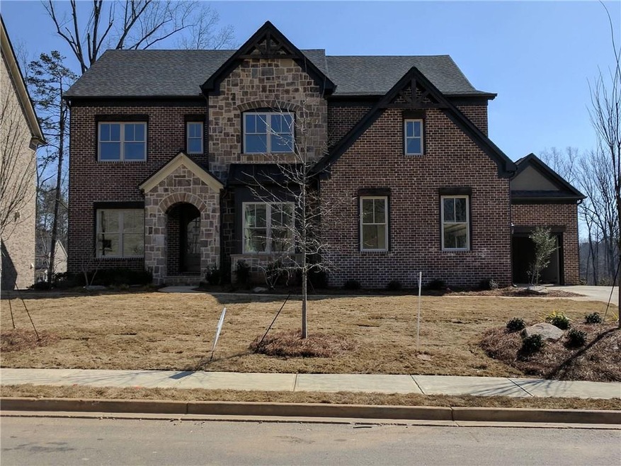 Beautiful brick and stone home with covered entry.