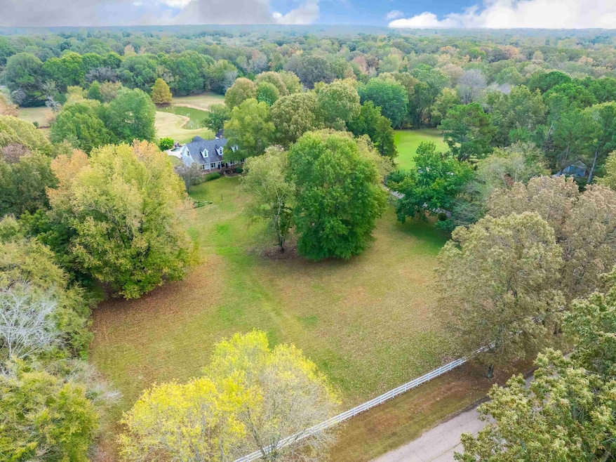 Birds eye view of property with a view of trees