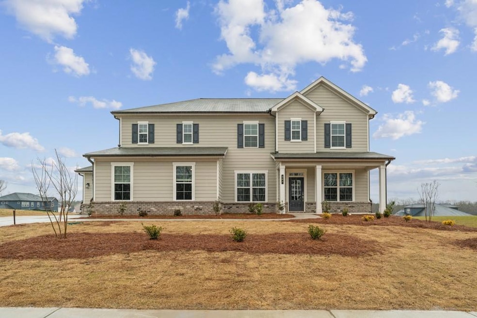 View of front of house featuring brick siding and 