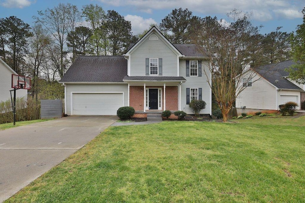 Traditional home featuring an attached garage, con