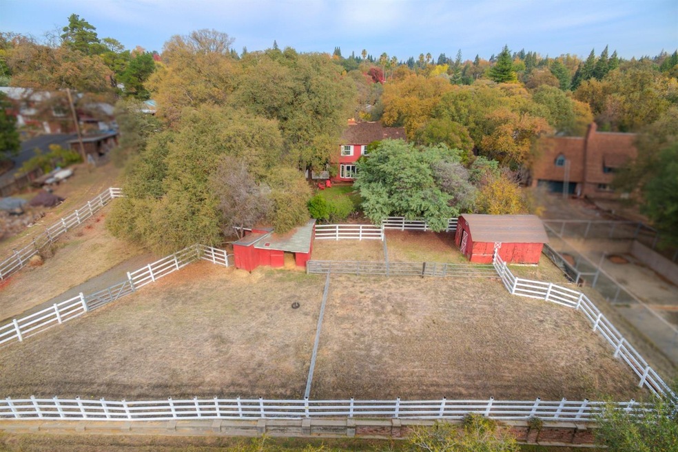 The barn and stable with the fencing out in the fr