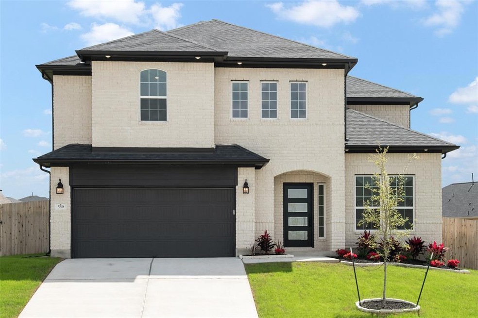 View of front of house featuring driveway, roof w