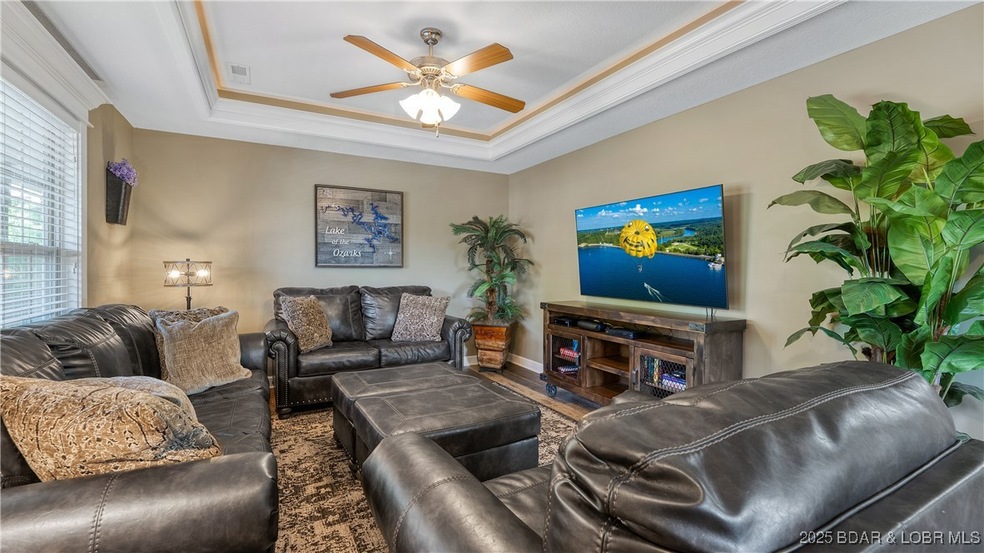 Living room has coffered ceiling with crown mouldi