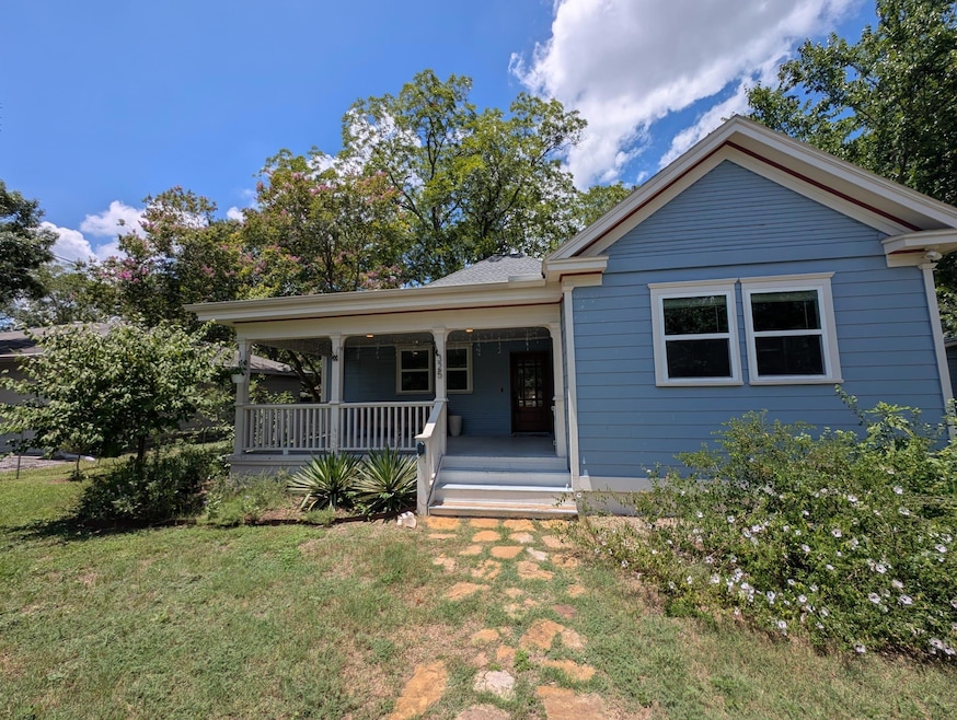 View of front facade with a porch and a front yard