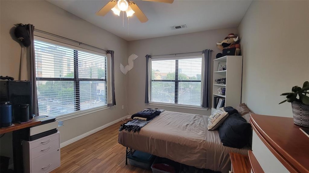 Bedroom featuring light wood-style flooring and a ceiling fan