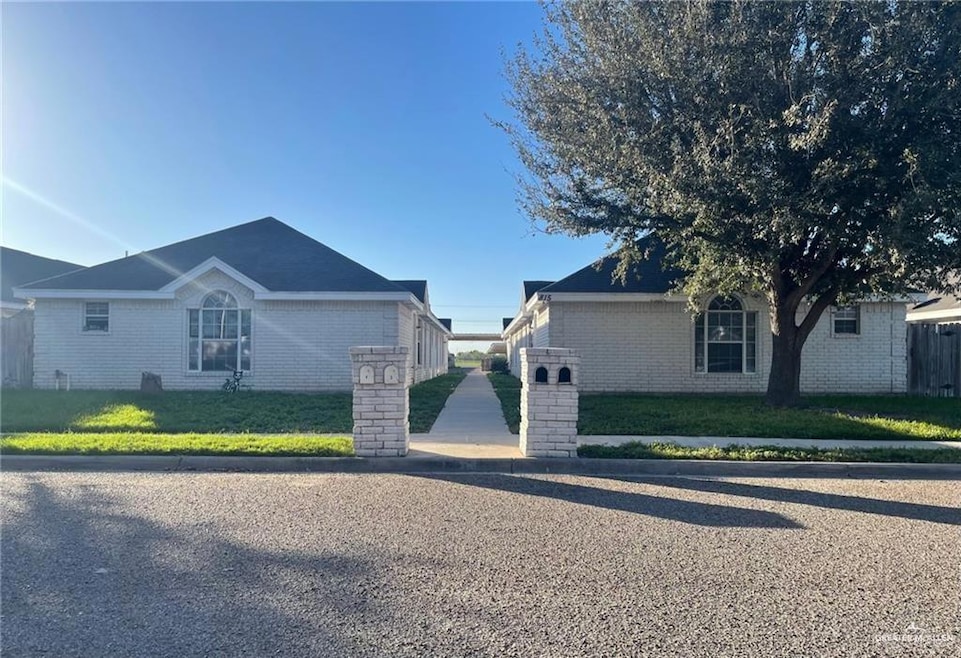 View of side of home featuring a yard