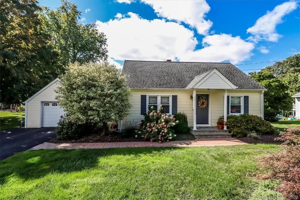 Charming three bedroom cape on large flat acre lot in town.