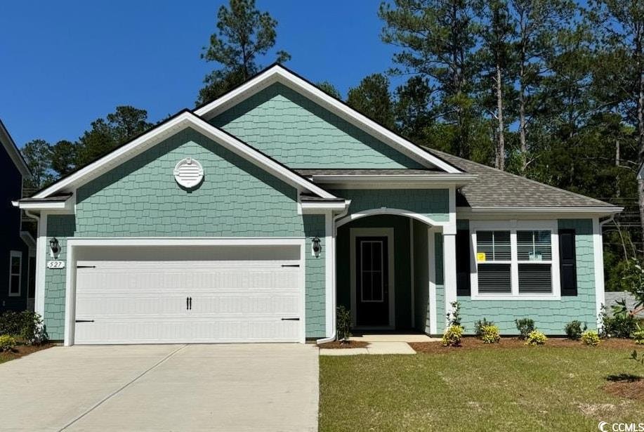 View of front of home with an attached garage, a f