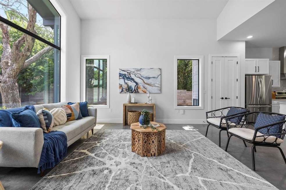The high ceilings, large windows, and neutral colo