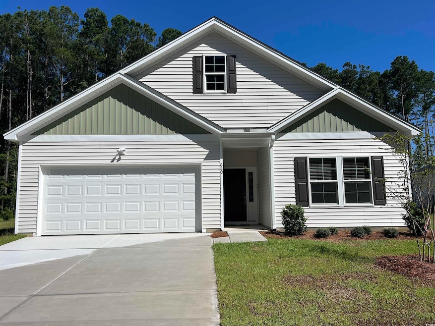 View of front of property featuring concrete driveway, board and batten siding, a front lawn, and an attached garage