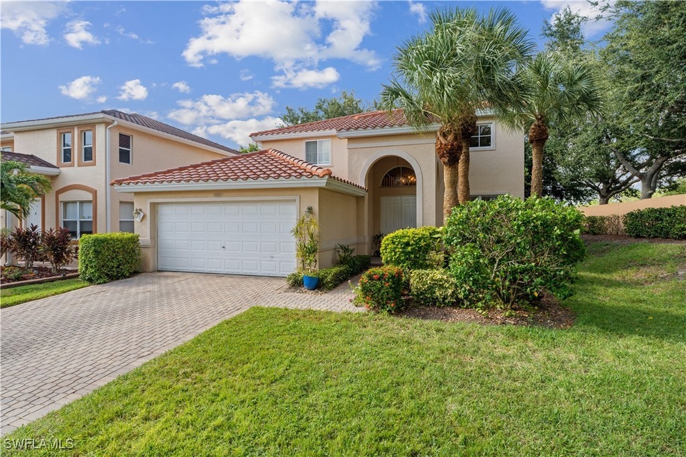 Mediterranean / spanish-style house featuring a ga