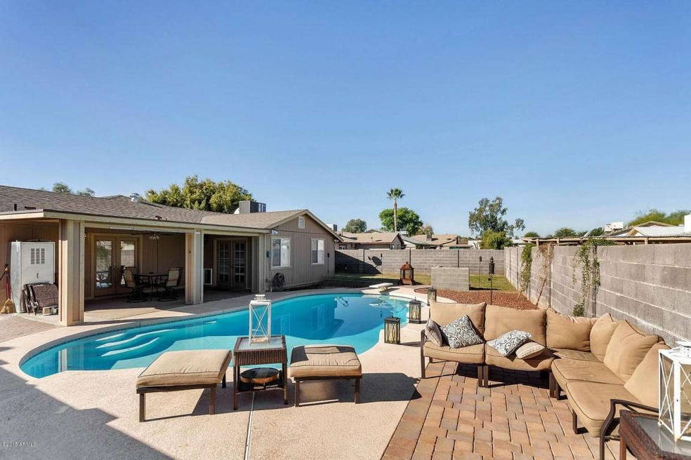 View of sparkling pool, patio  & yard