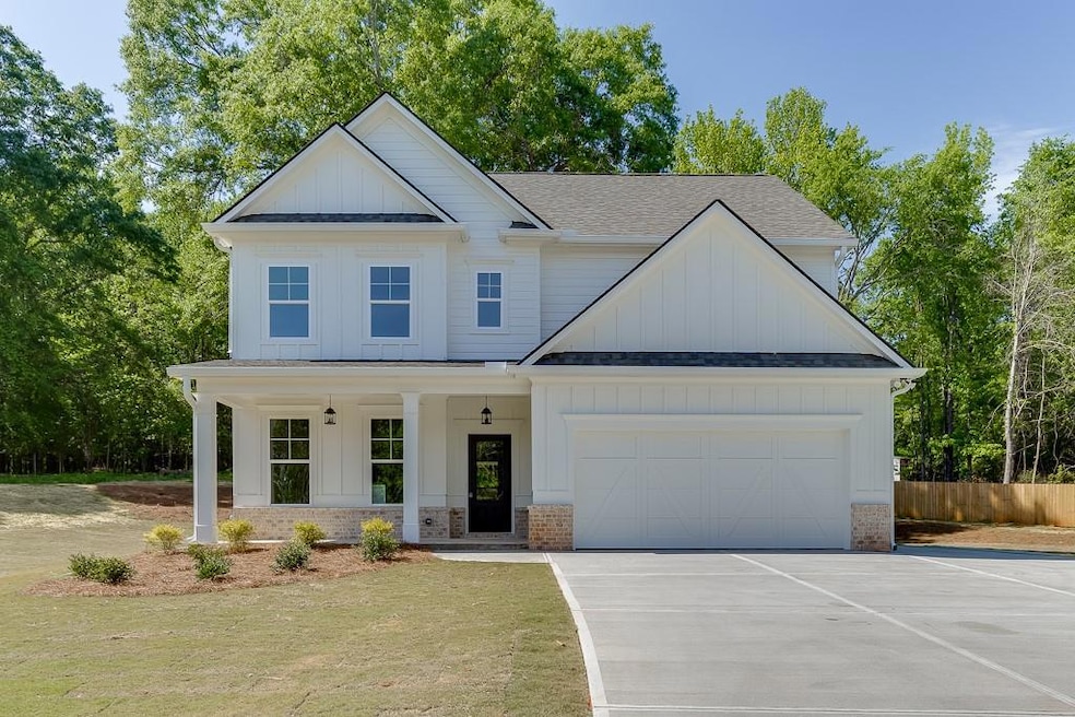 Modern inspired farmhouse featuring a garage, roof