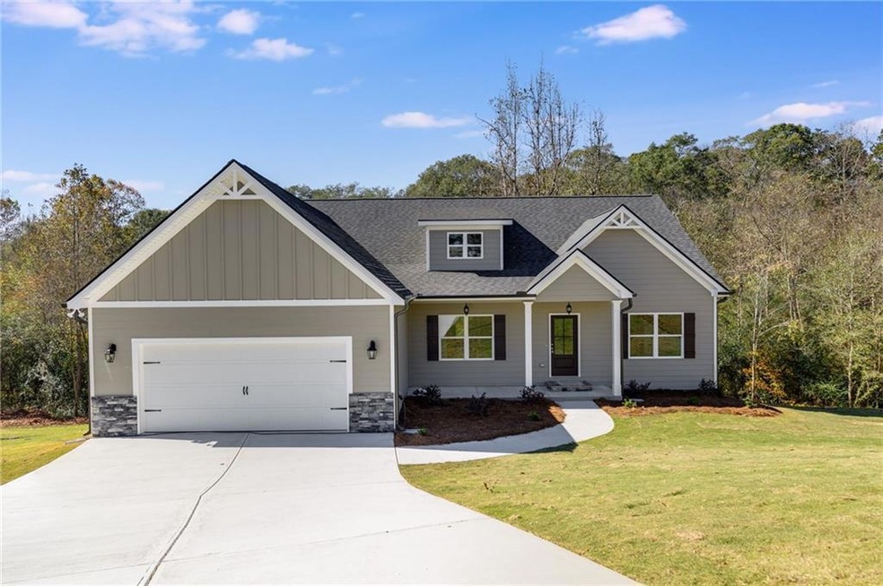 Craftsman inspired home featuring a garage and a f