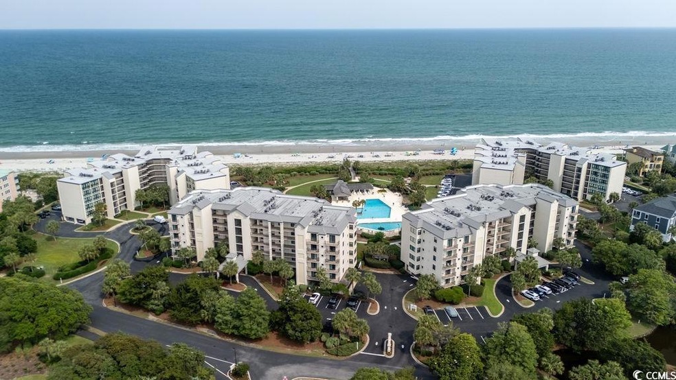 Drone / aerial view of apartment complex and expansive coastline