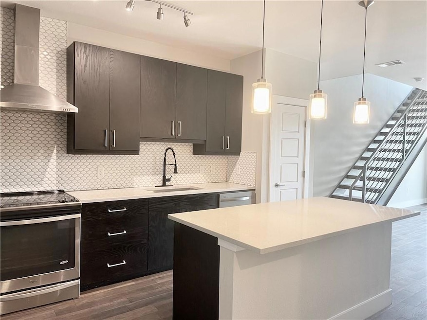 Kitchen with stainless steel appliances, wall chi