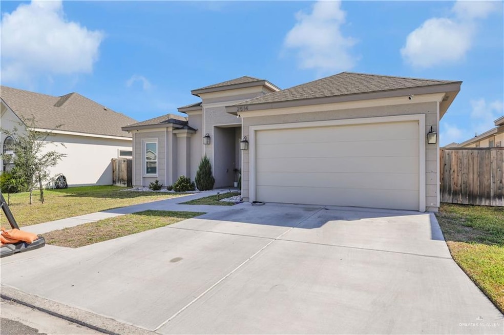 View of front of home featuring concrete driveway, an attached garage, stucco siding, and roof with shingles